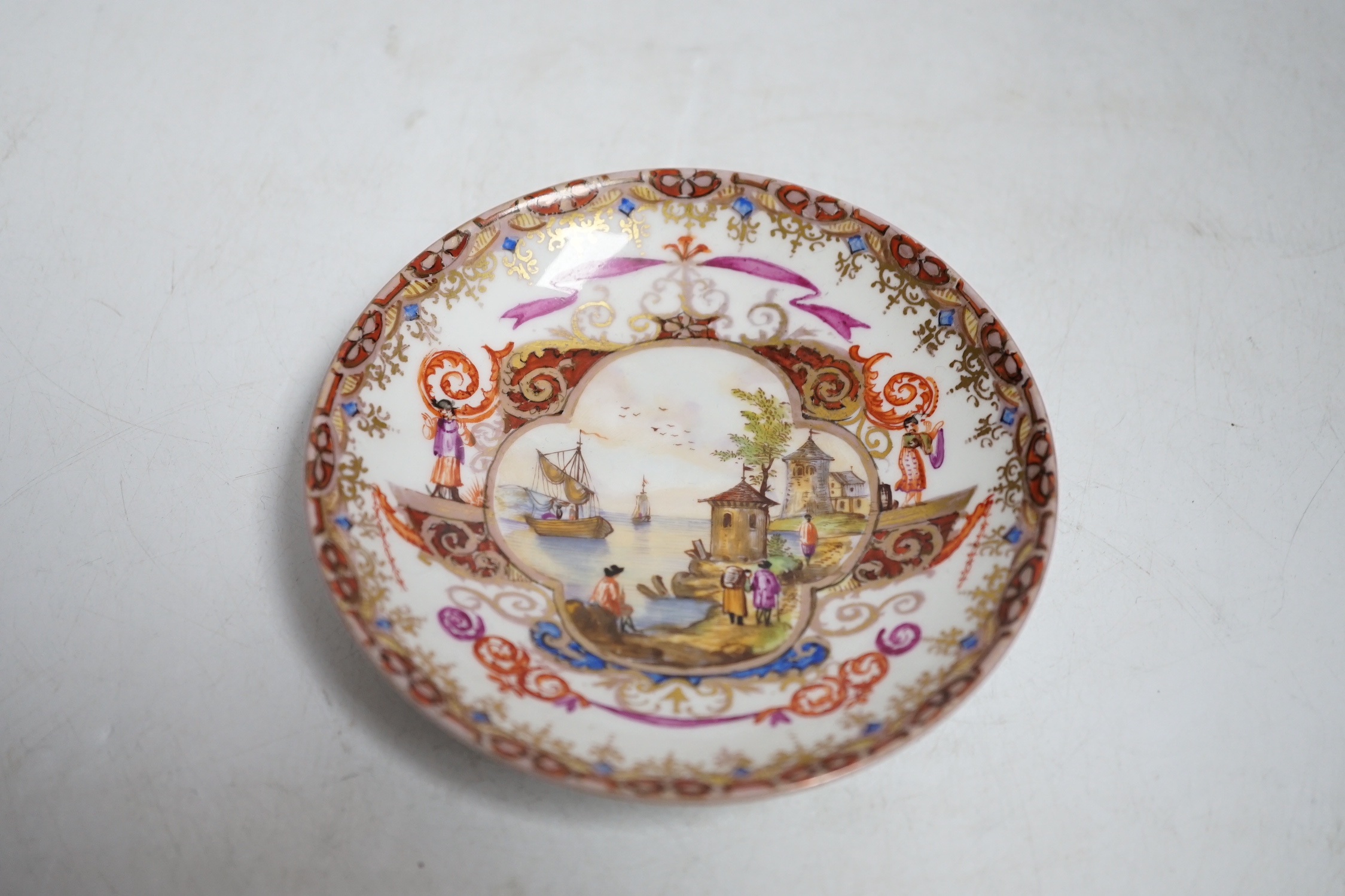 A miniature Dresden teacup and saucer in Meissen-style, cup 4.5cm